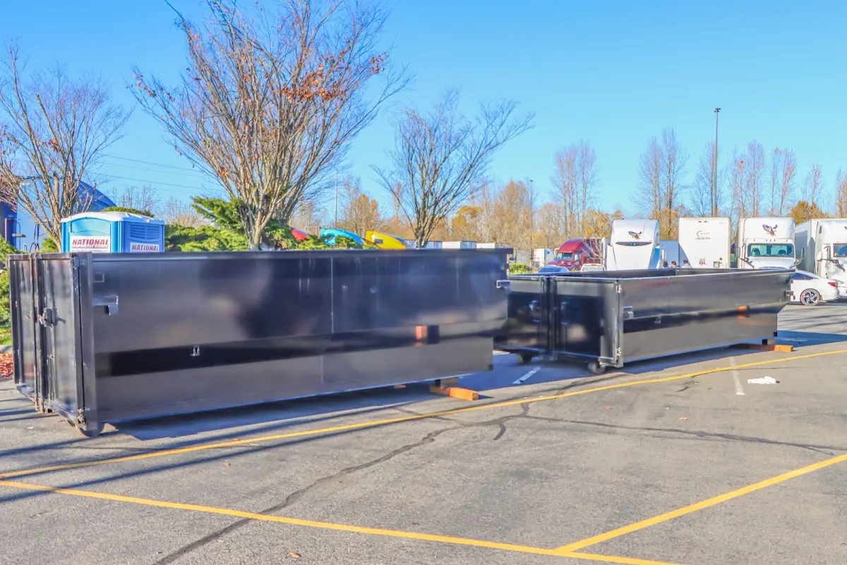 Professional dumpster rental service with roll-off container on residential driveway in Union Mill